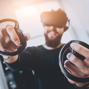 guy with a VR headset and controllers gaming