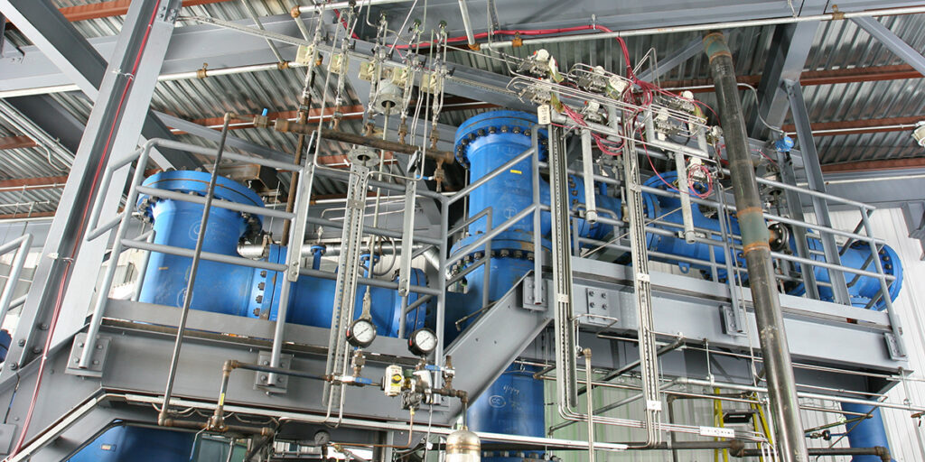 large blue piping and gray scaffolding inside a Flex Fuel facility